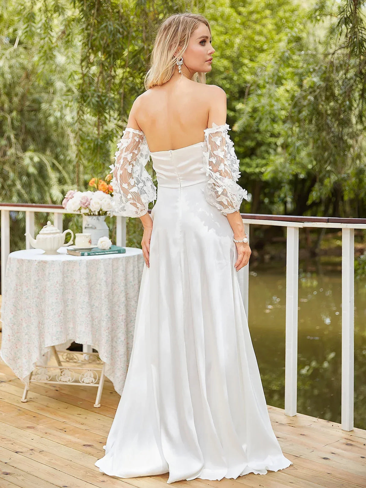 Back view of an off-shoulder mermaid wedding dress featuring lace details and a floor-length silhouette, perfect for brides.