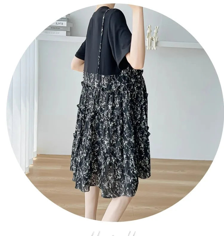 Elegant black floral maternity dress with ruffled skirt, perfect for baby showers and summer events.