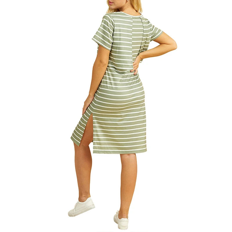 Back view of a striped short sleeve maternity dress in green, featuring side slits and knee-length design.