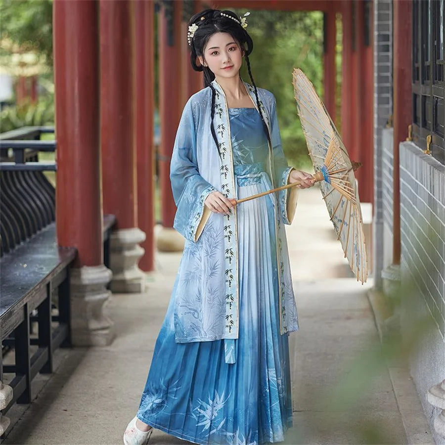 Elegant woman in traditional blue Hanfu outfit holding a parasol, set against a serene outdoor backdrop.