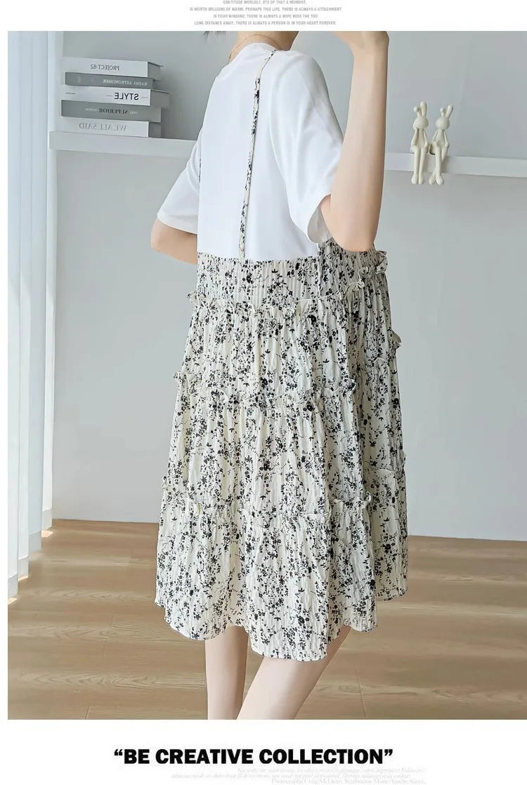 Elegant floral maternity dress featuring tiered design and a relaxed fit, perfect for summer baby showers.