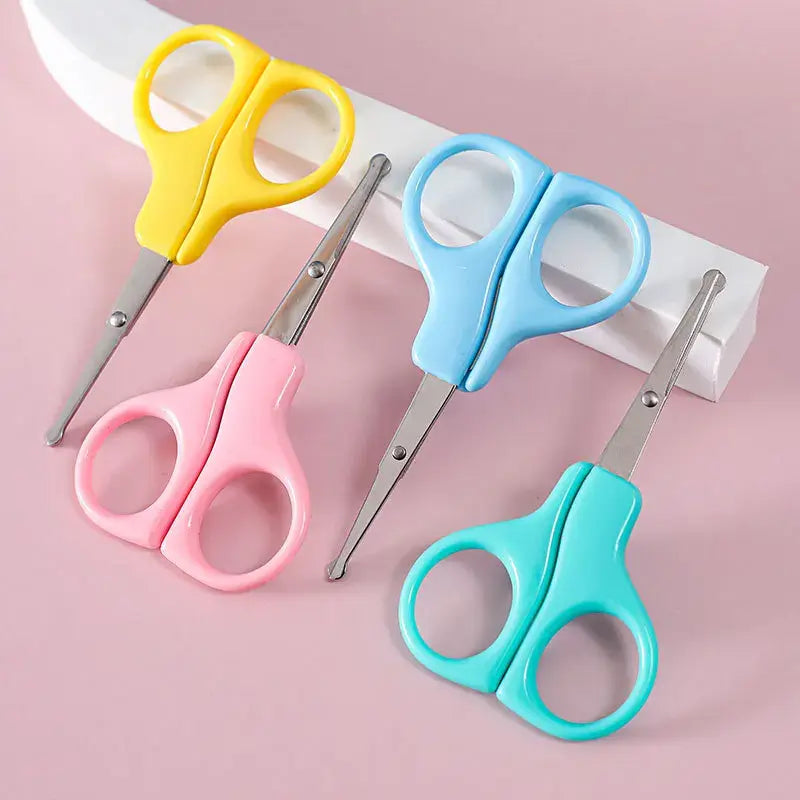 Colorful baby nail scissors in pink, yellow, blue, and green, perfect for newborn nail care and trimming.