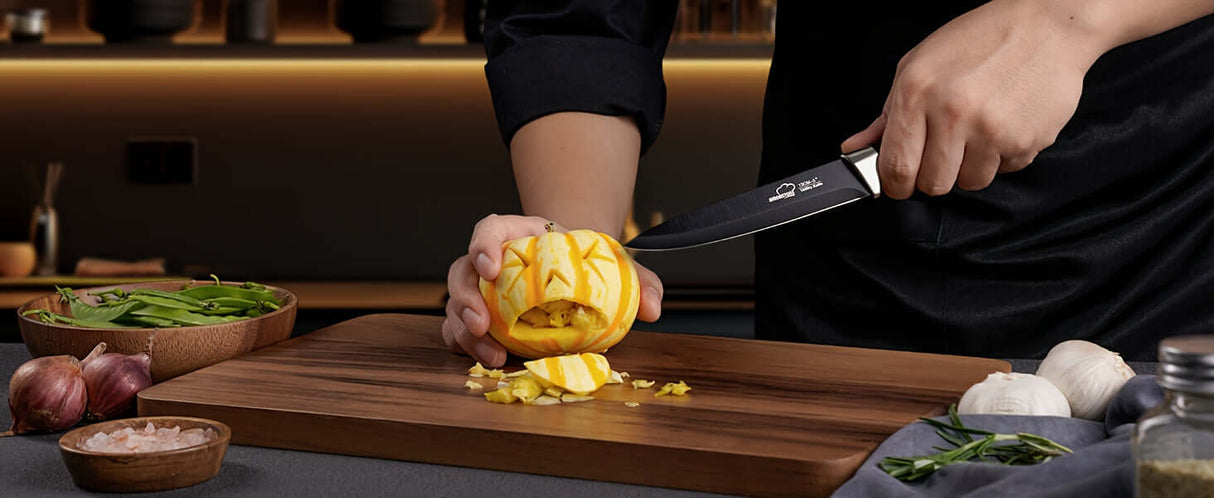 Amorston 20pcs Knife Set - Premium kitchen knives slicing through a pumpkin on a wooden cutting board.
