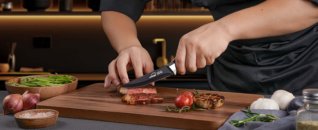 Person using Amorston knife set to slice meat on a wooden cutting board in a modern kitchen.
