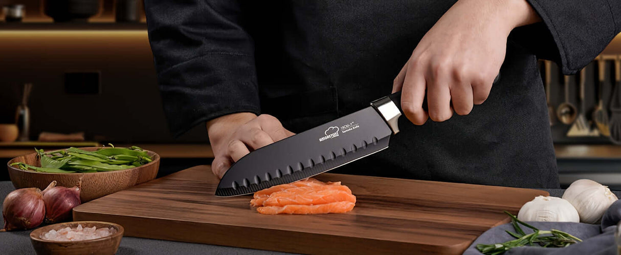 Amorston premium knife set used to slice salmon on wooden cutting board in modern kitchen.
