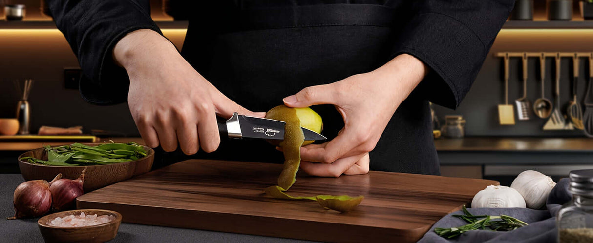 Person using Amorston stainless steel knife to peel a lemon on a wooden cutting board in a modern kitchen.