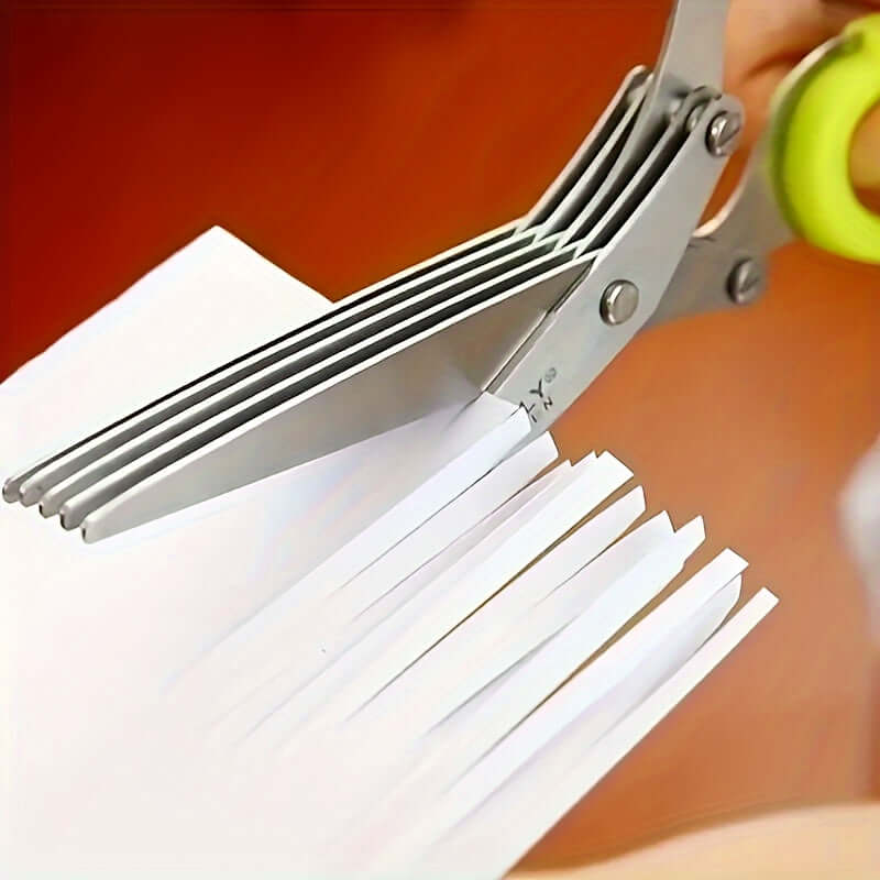 Durable stainless steel kitchen scissors cutting paper with multiple blades, showcasing versatile design for various tasks.