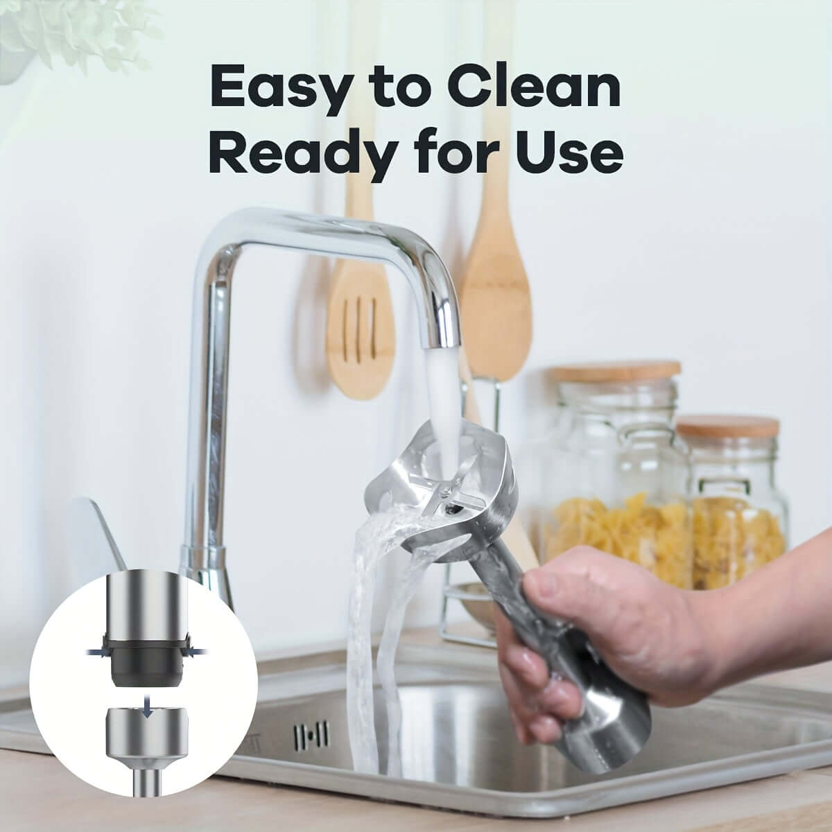 Person cleaning an immersion blender under running water in a kitchen sink, showcasing easy maintenance.
