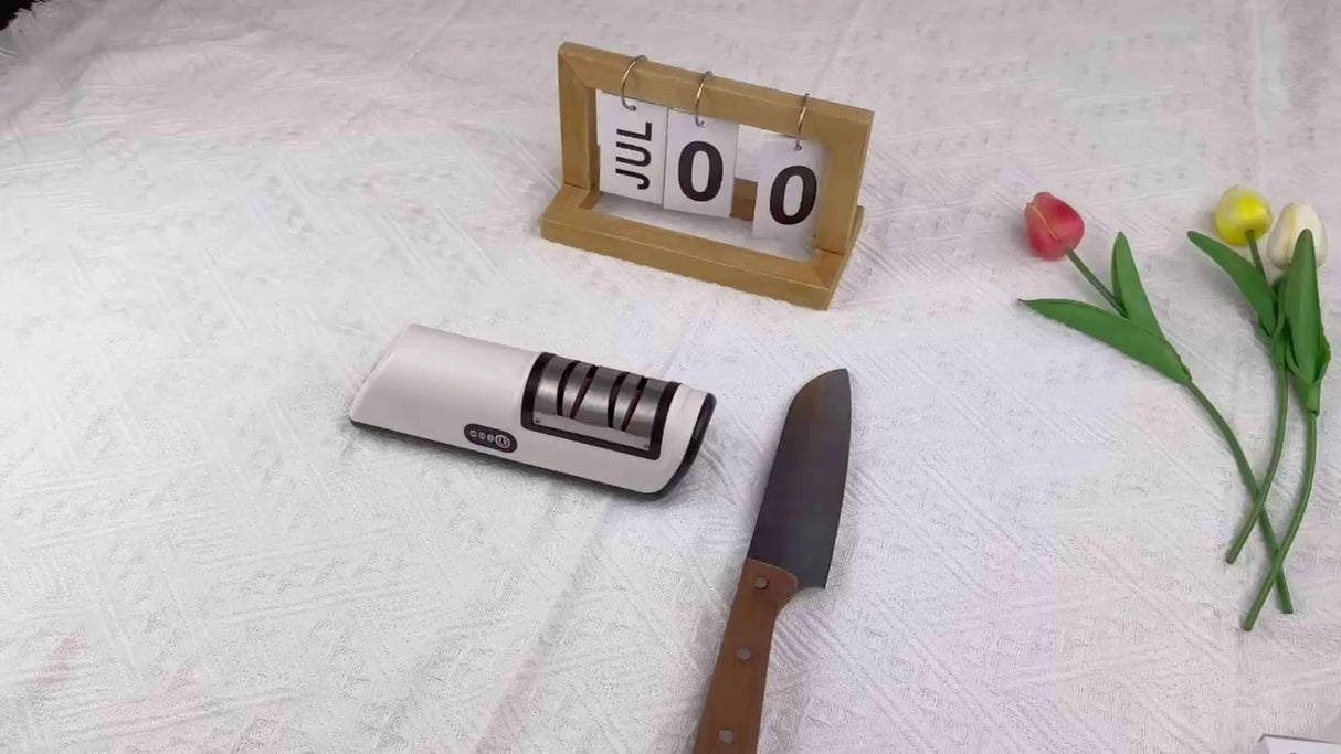 2-stage electric knife sharpener by ZERNBER, USB rechargeable design, placed next to a knife on a white tablecloth.