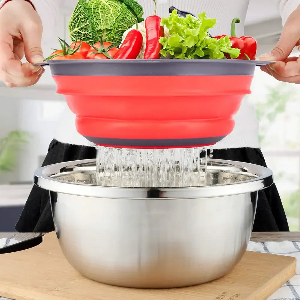 Eco-friendly silicone fruit and vegetable cleaning basket in action, draining water over a steel bowl.