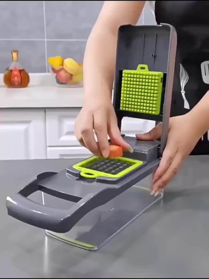 Person using an upgraded vegetable chopper set to slice vegetables in a kitchen setting.