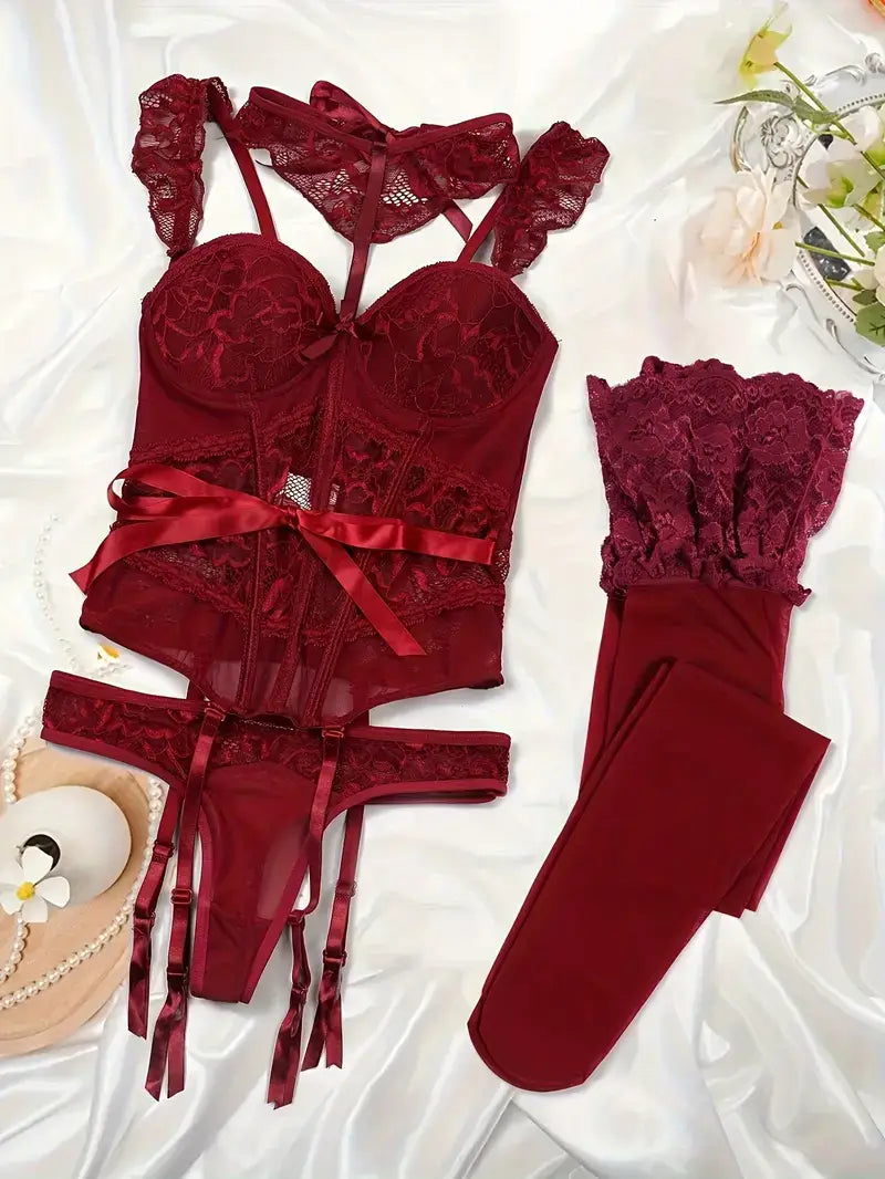 Luxurious women's lingerie set in deep burgundy with lace details and satin ribbons, displayed elegantly on soft fabric.