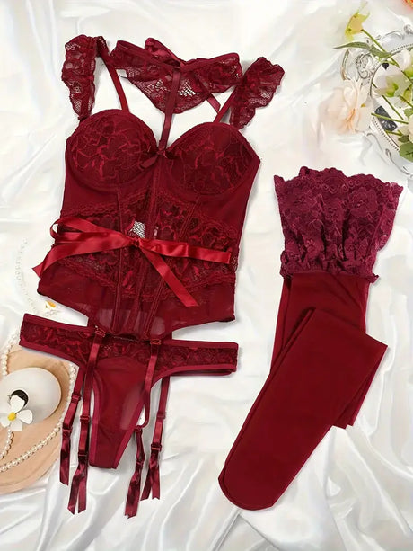 Luxurious women's lingerie set in deep burgundy with lace details and satin ribbons, displayed elegantly on soft fabric.