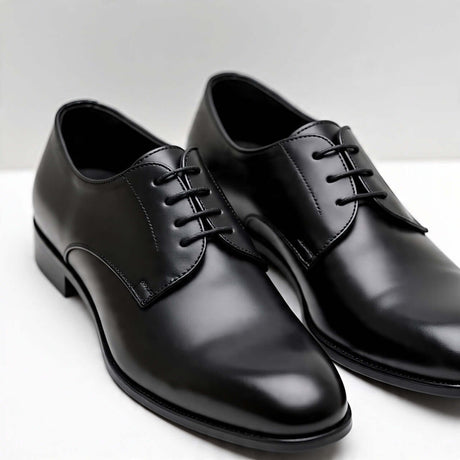 Elegant black women's Oxford shoes, featuring a classic design and polished finish, perfect for formal occasions.