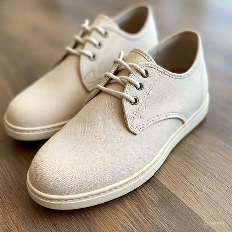 Women's beige canvas shoes with lace-up design, perfect for casual outings and stylish comfort.