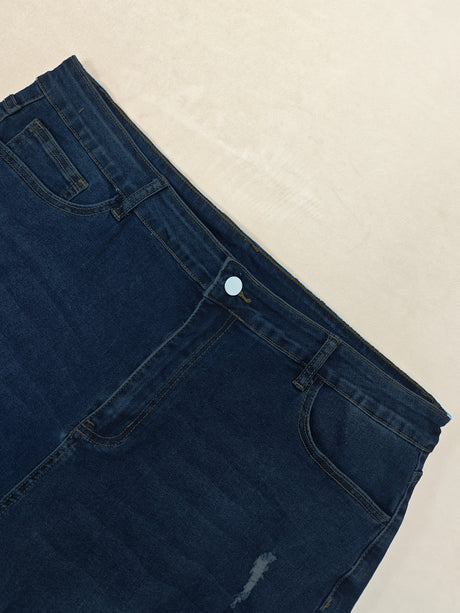 Close-up of New Ripped Skinny Jeans showcasing a dark wash with a button closure and distressed details.