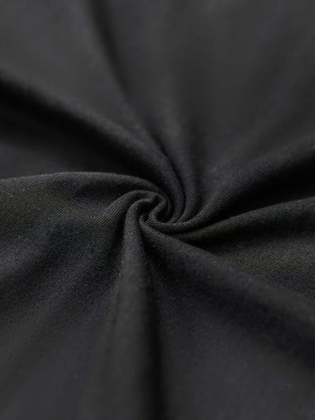 Close-up of soft, stretchy black cotton fabric, ideal for casual wear and comfortable clothing.