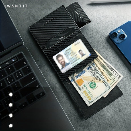Minimalist black leather wallet with cash, IDs, and card, placed next to a laptop and smartphone.