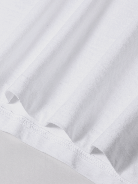 Close-up of soft white cotton fabric with slight stretch, perfect for a Y2K women's print t-shirt.