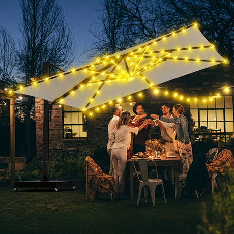 People enjoying a cozy outdoor gathering under a lighted cordless patio umbrella with remote control.