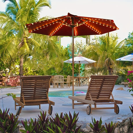 Cordless patio umbrella lights with remote control illuminating outdoor lounge area by the pool, surrounded by palm trees.