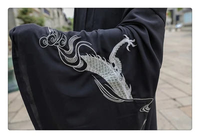 Close-up of black Han Dynasty costume sleeve featuring intricate dragon embroidery.