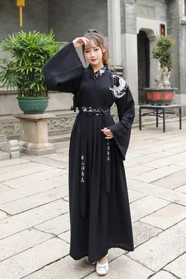Han Dynasty couple costume featuring a black swordsman outfit with elegant long sleeves and intricate details.