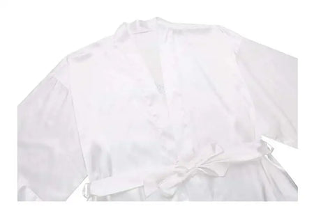 Elegant white satin bridesmaid robe with a tied waist, perfect for wedding day preparations.