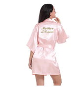 Light pink satin robe for Mother of the Groom with elegant gold text, perfect for bridal parties.