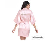 Light pink satin bridesmaid robe with elegant lettering, perfect for summer weddings and bridal parties.