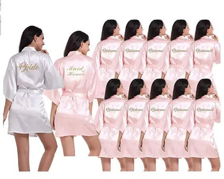 Light pink satin bridesmaid robes and white 'Bride' robe for weddings, featuring elegant designs and short sleeves.