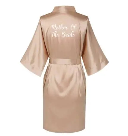 Rose gold satin robe for mother of the bride, featuring elegant lettering on the back, perfect for wedding day attire.