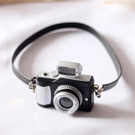 Mini camera for dollhouse, 1/12 scale, perfect for baby photography props. Black plastic design.