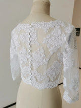 Elegant white crystal beaded wedding jacket with 3/4 sleeves, featuring intricate lace detailing and button closure.