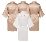 Rose gold and white satin robes for brides, bridesmaids, and mother of the bride with elegant text designs.