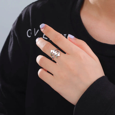 Stylish woman's hand wearing a unique silver African map ring, showcasing fashion jewelry for daily wear.