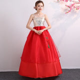 Traditional red Korean hanbok dress with floral design and a flowing skirt, ideal for cultural dances and celebrations.