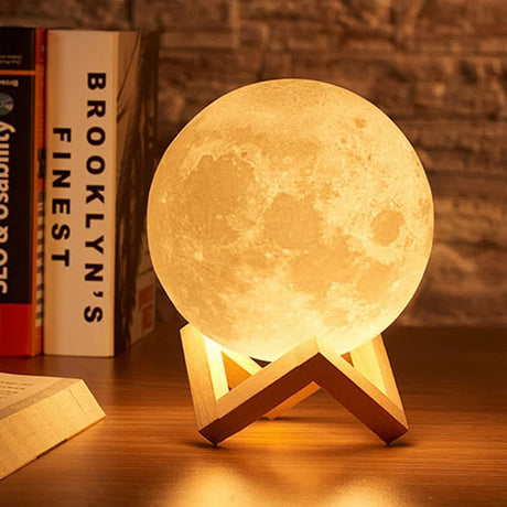 LED Moon Galaxy Book Light on a wooden stand, perfect for home decor and as a unique gift.