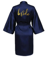 Navy satin kimono robe with 'bride' in gold lettering, perfect for bridal parties and wedding preparations.