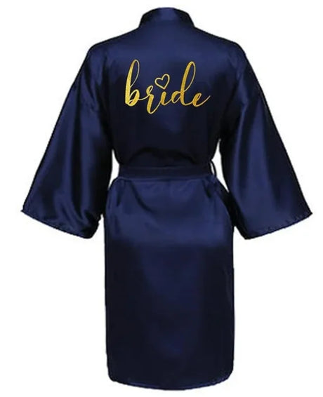Navy satin kimono robe with 'bride' in gold lettering, perfect for bridal parties and wedding preparations.
