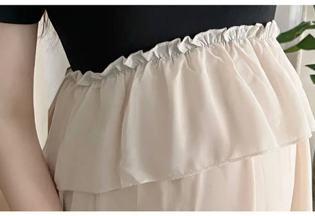 Close-up of the gathered waist detail of a stylish short sleeve maternity dress in soft fabric.