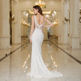Elegant back view of a MisShow white mermaid wedding dress featuring lace, pearls, and a floor-length design.