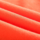 Close-up of soft, vibrant coral fabric showcasing texture, ideal for clothing.