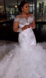 Elegant woman in a white plus size Arabic mermaid wedding dress with tulle and crystal embellishments.
