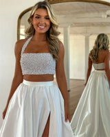 Model wearing a stylish taffeta detachable wedding skirt with a high side slit and a beaded strapless top.