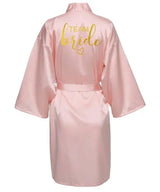 Back view of Team Bride satin robe in light pink with gold lettering, perfect for bridal parties.