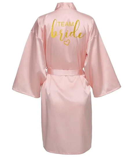 Back view of Team Bride satin robe in light pink with gold lettering, perfect for bridal parties.