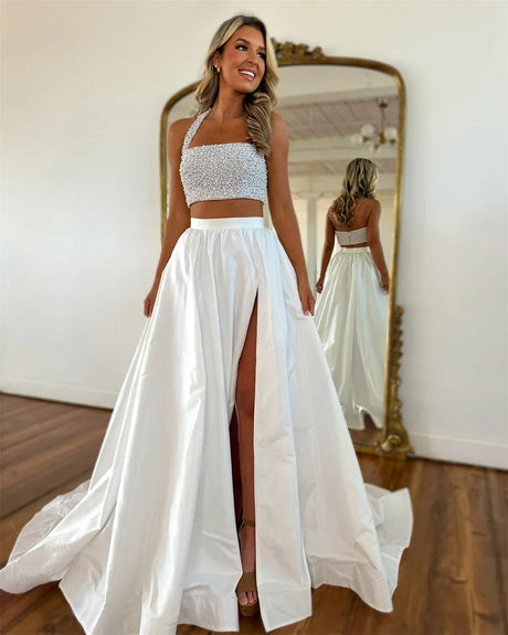 Model wearing a taffeta detachable wedding skirt with high side slit and beaded strapless top, showcasing modern bridal fashion.