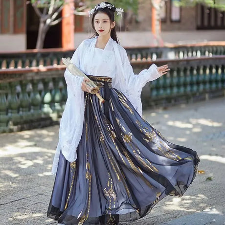 Elegant woman in a vintage Tang Dynasty blue hanfu costume with floral details and a white shawl.
