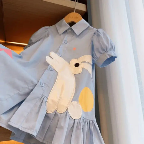 Light blue girls dress with cartoon bunny and colorful accents, perfect for summer fashion.